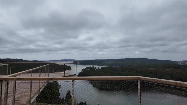 Furna do sapo viewpoint overlooking a winding river estuary surrounded by green forests under an overcast sky