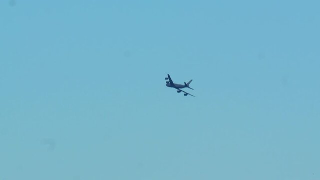 B-52 Stratofortress bomber aircraft flying across a clear blue sky during a daytime military training mission in 120fps 4K Slow Motion