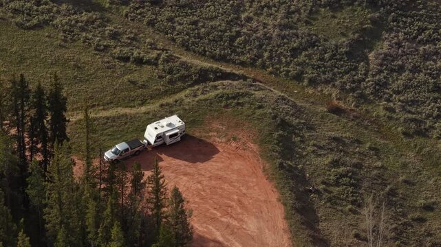 Aerial of travel trailer camping in Ashley National Forest in Utah Uinta Mountains in spring time