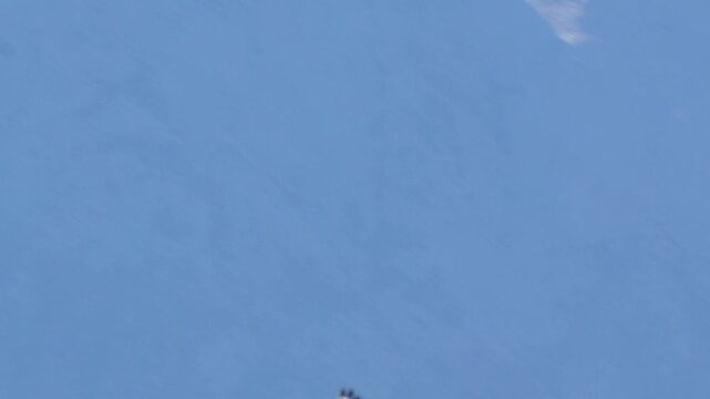Sky in a clear blue color stretching across the horizon on a bright sunny day with a serene atmosphere in 120fps 4K Slow Motion