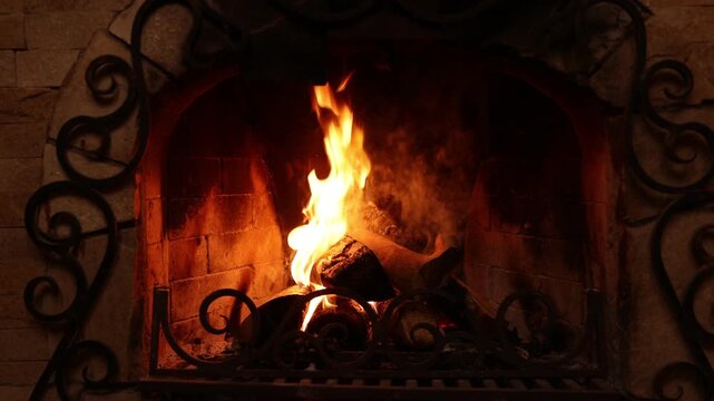 Wood burning in fireplace at home. Cozy atmosphere