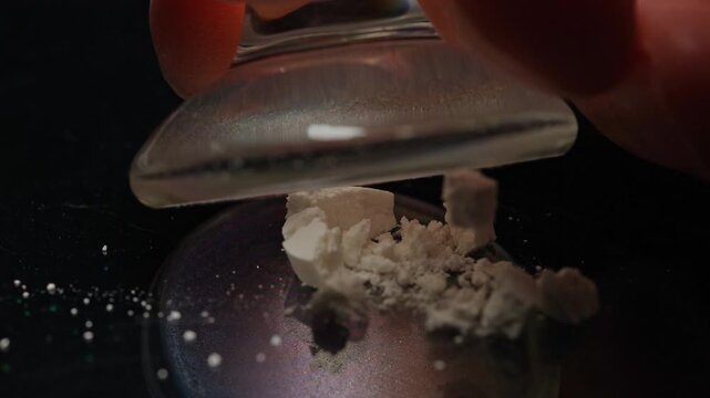 Addictive person crushing prescription opioid drug of fentanyl to inject, snort sniff or smoke concept. Educational concept of synthetic opioids and fentanyl crisis. Abuse of prescription pain meds