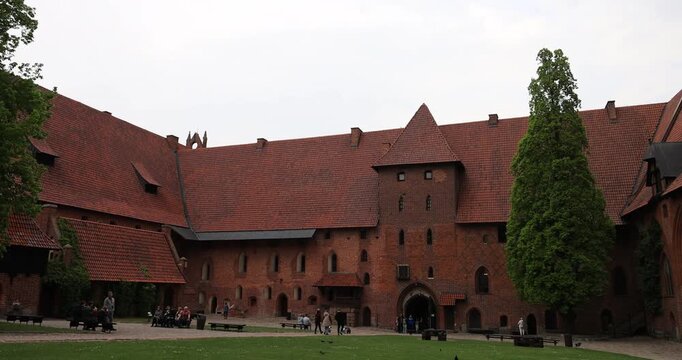 Poland Malbork Castle tourism coutyard. Medieval castle of the Teutonic Order. 13th century, Largest castle in the world by land area, 52 acres. Historical buildings. Educational displays.