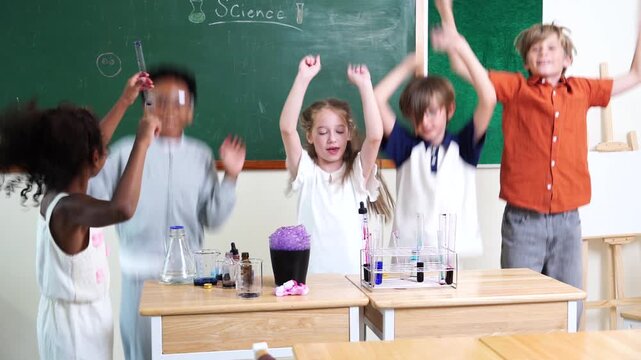 group of boys and girls, of multinational nationality jumping excited in front of their classmates learning science, mixing chemicals, holding test tubes in their classroom at school