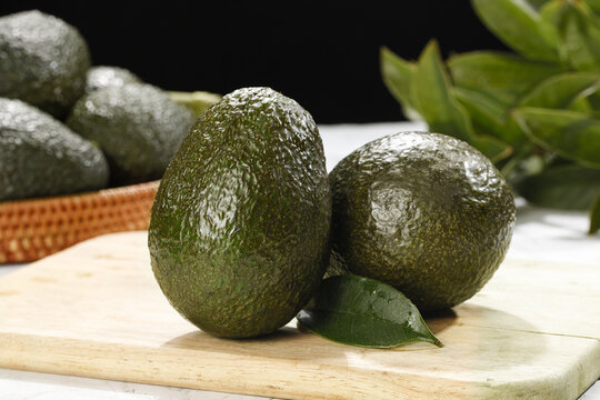 Fresh Ripe Avocados on Wooden Cutting Board Ready for Healthy Cooking and Meal Preparation