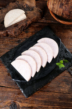 Fresh Sliced Guangxi Lipu Taro Root on Slate Board with Rustic Bread
