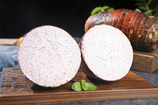 Fresh Taro Root Slices from Guangxi China on Wooden Board - Lipu Variety Asian Vegetable