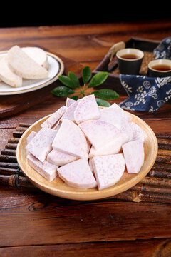 Fresh Lipu Taro Root Slices from Guangxi China with Traditional Tea Service on Wooden Table