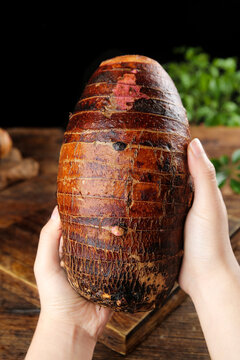 Fresh Taro Root Lipu Variety from Guangxi China Held in Hands Showing Natural Brown Striped Texture