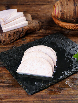 Fresh Sliced Taro Root Lipu on Slate Board - Traditional Guangxi Chinese Cuisine Ingredient