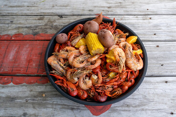 Fototapeta na wymiarA platter on the table features a generous amount of boiled crawfish and shrimp, a classic Louisiana style seafood boil. New Orleans, Louisiana, USA 