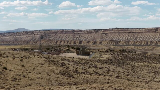 Aerial panning on oil rig in northeastern Utah near Vernal in high desert in spring time