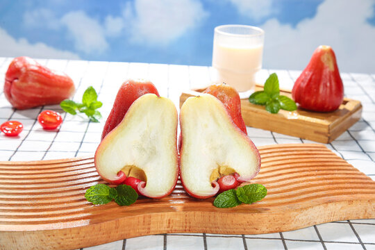 Fresh Red Wax Apples Rose Apples Sliced on Wooden Board with Mint and Milk Hainan Tropical Fruit