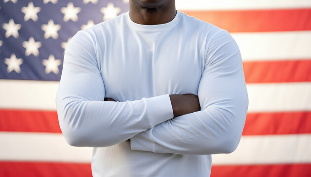 Middle aged African man wearing a blank white long sleeve shirt posing near an american flag