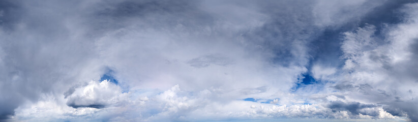 Obraz premium Dramatic Cloudscape Panorama of Rolling Storm Clouds and Soft Blue Sky Over Horizon