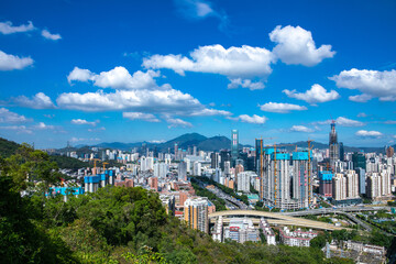 Shenzhen city skyline and mountains under blue sky © VuVan