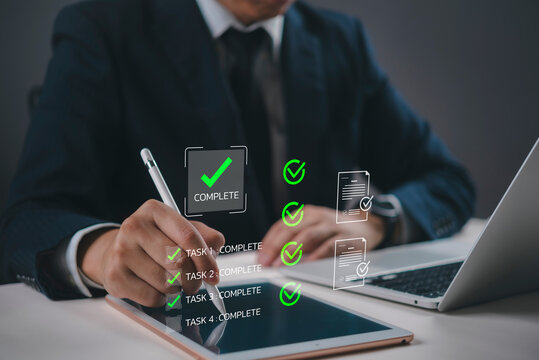 Businessman checking digital checklist on tablet for task completion