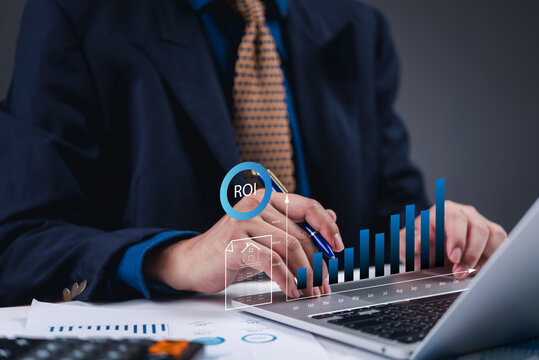 Businessman analyzing real estate investment ROI financial growth chart hologram