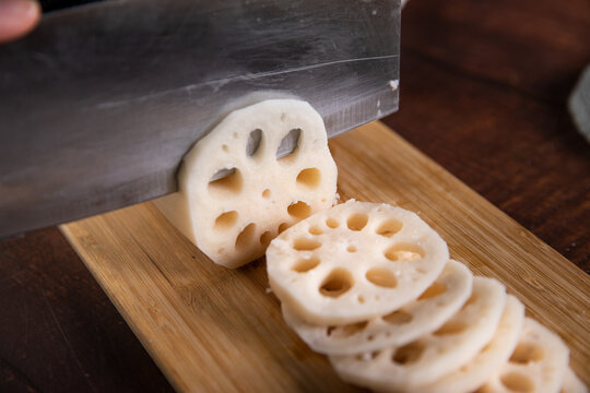 Fresh Lotus Root Sliced on Wooden Cutting Board