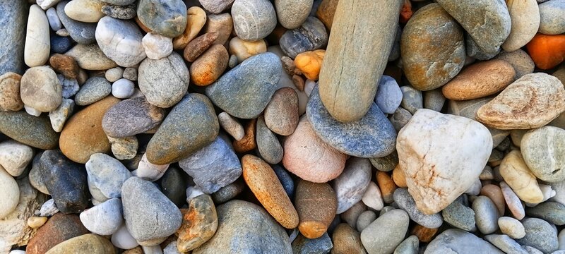 Macro shot of raw crushed aggregate stones for concrete mixing. Essential raw material for heavy construction, foundation building, and infrastructure projects.