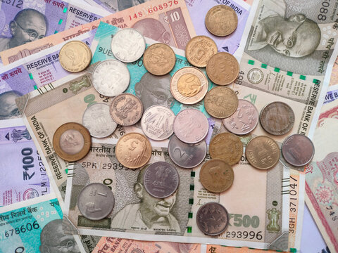 Indian rupee notes with coins for savings and economic growth ideas