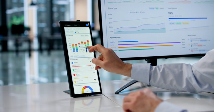 Experienced Financial Analyst Uses Touchscreen To Track Revenue