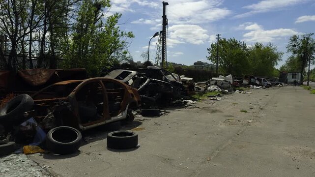 Destroyed And Burnt Cars Abandoned Outdoors. Rusty Vehicles In Scrapyard After Crash. Environmental Pollution