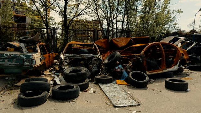 Abandoned Burnt and Crushed Cars in Outdoor Junkyard. Vehicle Disposal Site