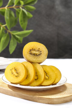 Fresh Yellow Kiwi Fruit Slices Cut on White Plate - Healthy Tropical Vitamin Rich Food