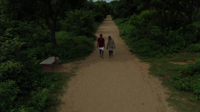 Aerial view of devotees walking on the sacred Govardhan Parvat Parikrama Marg surrounded by lush greenery, Mathura.