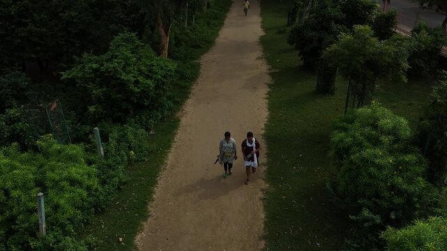Aerial view of devotees walking on the sacred Govardhan Parvat Parikrama Marg surrounded by lush greenery, Mathura.