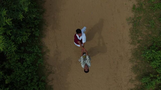 Aerial view of devotees walking on the sacred Govardhan Parvat Parikrama Marg surrounded by lush greenery, Mathura.