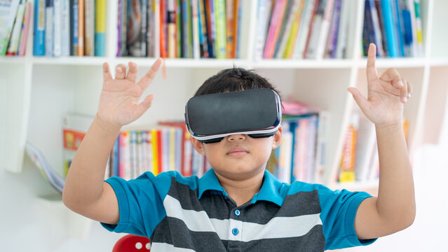 Young Boy Using Virtual Reality Headset for Modern Education in Library