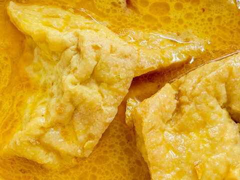 Close Up Macro of Indonesian Tahu Gulai Fried Tofu in Yellow Coconut Curry Gravy