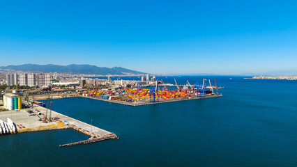 Obraz premium Izmir, Turkey.Industrial aerial view of Izmir Port container storage area with multiple cranes and stacked containers on sunny day. Aerial view.
