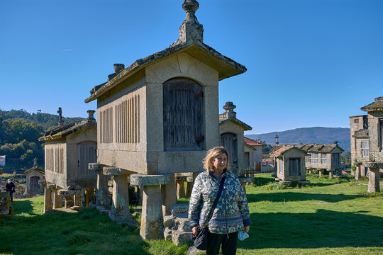 Portrait of a woman enjoying the charm of Lindoso iconic granaries in Portugal