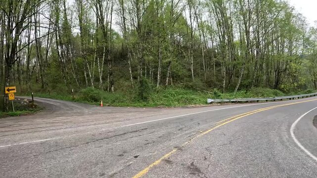 4K b roll car driving footage captured with an action camera along a highway 503 Lewis River road in Washington, USA. Scenic Pacific Northwest wilderness and evergreen woodland landscape