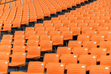 Fototapeta premium Empty Orange Spectator Seats in Stadium