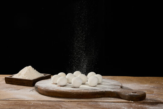 Glutinous Rice Balls Dusted with Flour on Wooden Board