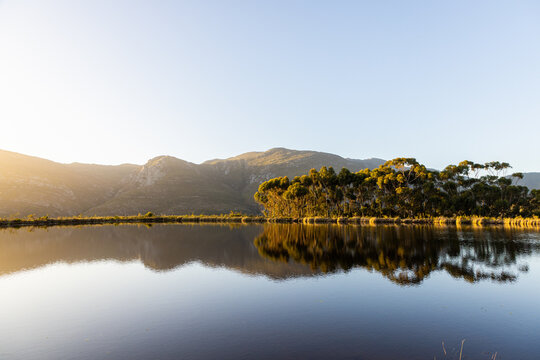 placid pond at sunset, overlooking Klein Mountains, Stanford, South Africa