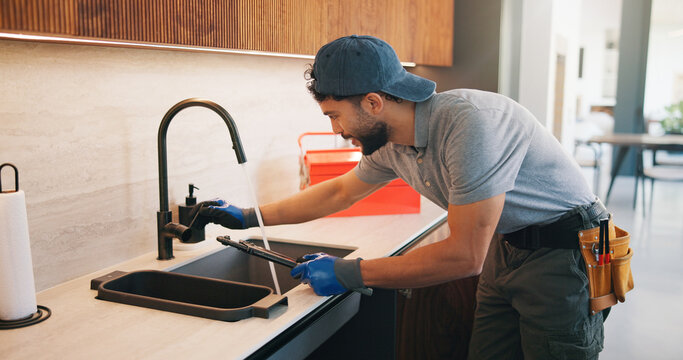 Repair, check or plumber in kitchen with tools, tap testing or sewer review in system maintenance. Inspection, servicing or handyman with water, faucet installation or restoration in home improvement