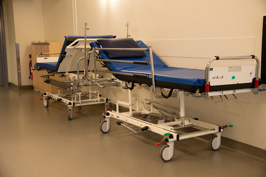 Medical stretchers in empty hospital corridor