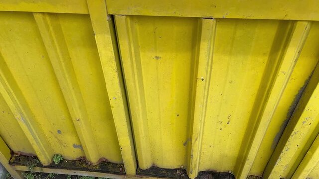 Close up of yellow galvalume sheet texture on storefront exterior