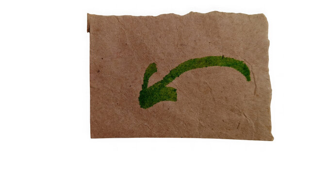 Green arrow pointing left on brown brick wall