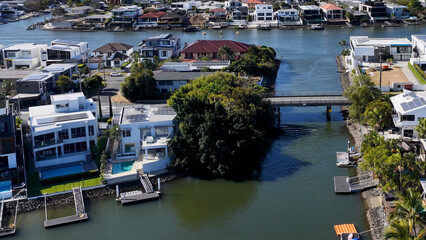 Aerial View of Modern Waterfront Homes and Canal Bridge in Gold Coast © blueringmedia