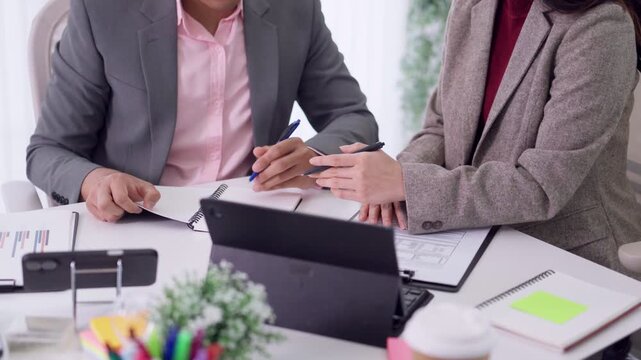 business team meeting planning strategy with tablet computer document review discussion collaboration office workspace professional teamwork partnership