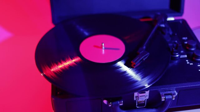 Vintage record player with spinning vinyl and neon lighting for retro music vibes