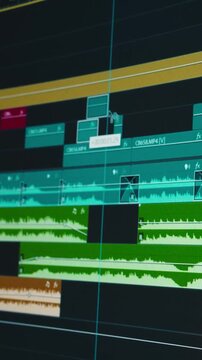 Close-up cinematic footage of a video editor working inside professional editing software. Timeline editing, color grading, sound design, waveform adjustments, and creative post-production workflow .