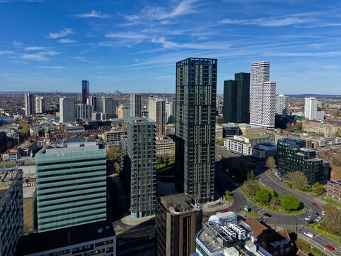 Croydon skyscrapers and roundabout with traffic in town center. Low altitude aerial view of modern architecture. Urban area in Greater London on a sunny day. 
