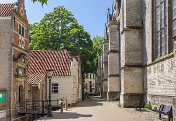 Fototapeta premium Small street along the side of the historic Sint Jan church in Gouda, Netherlands